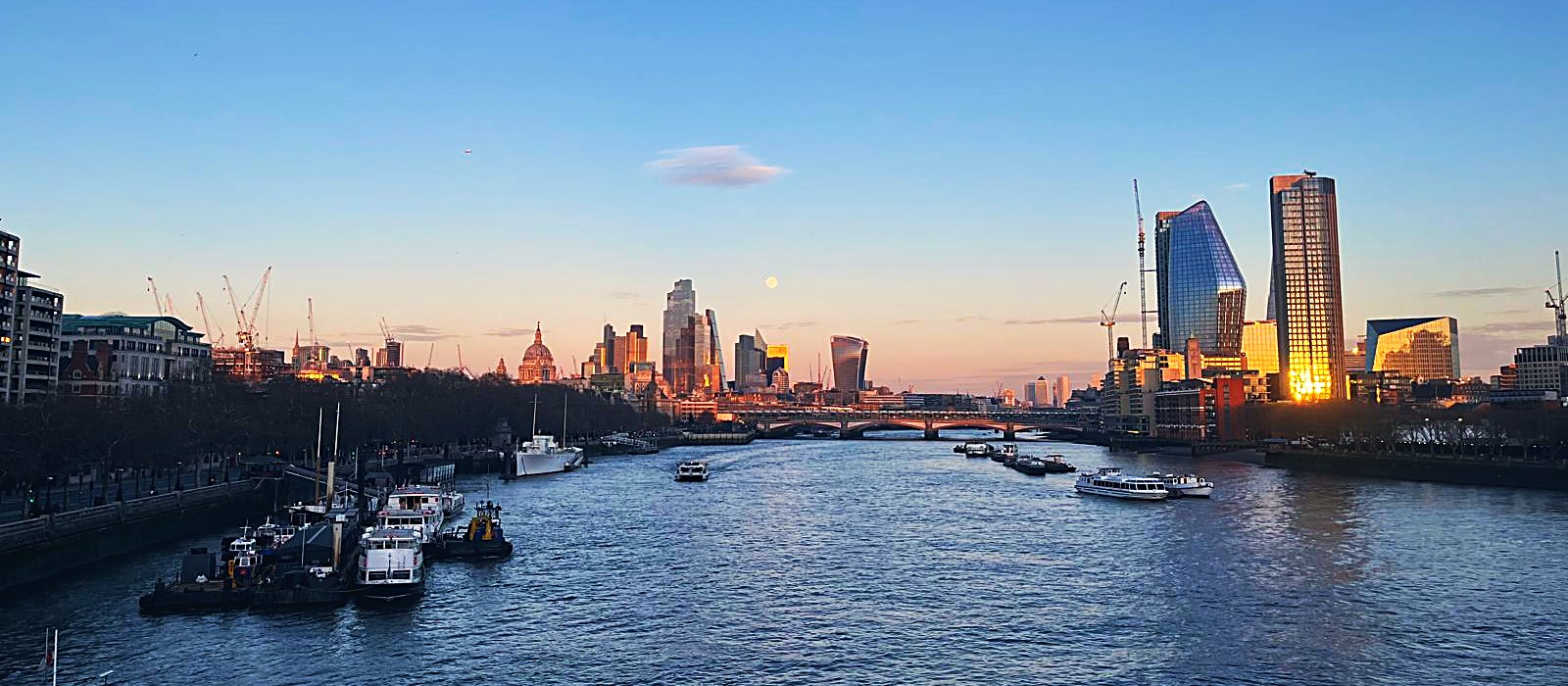 The River Thames at sunset, looking towards the City of London skyline